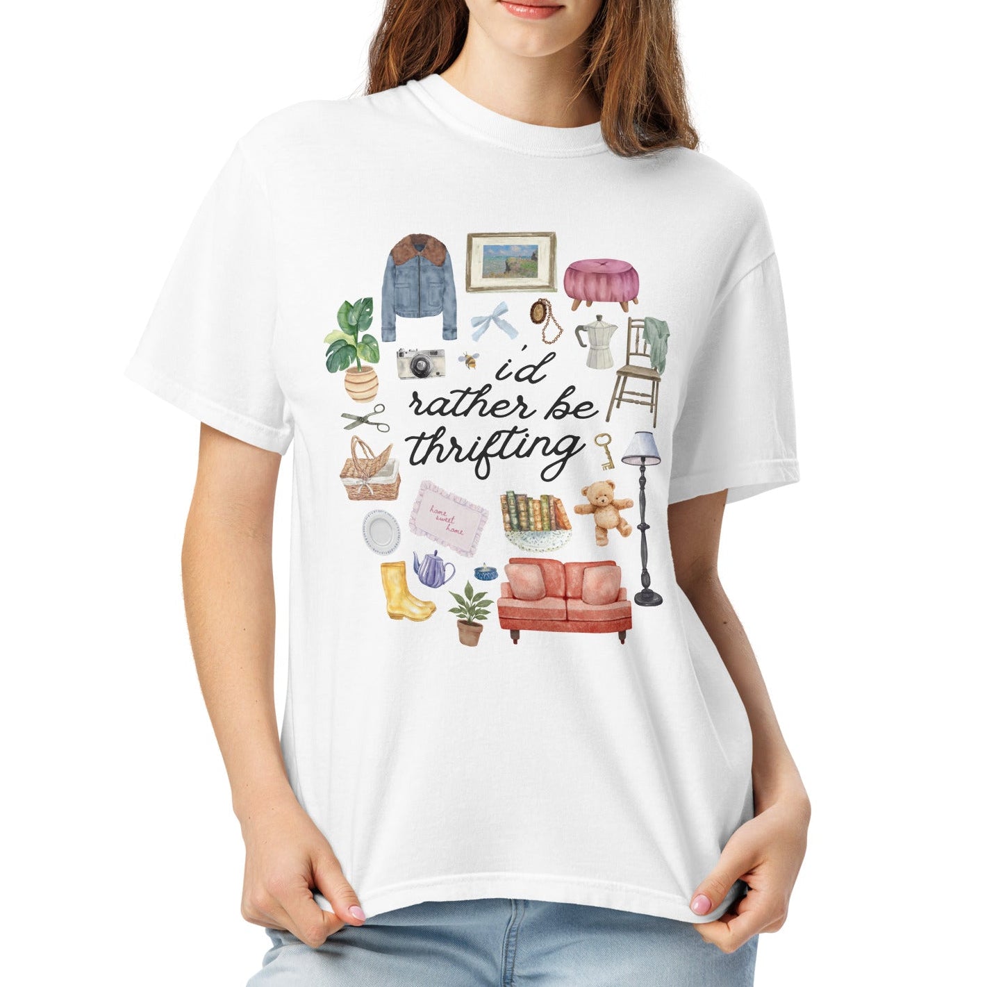 Woman wearing a white t-shirt with graphic items and "i'd rather be thrifting" text on a white background