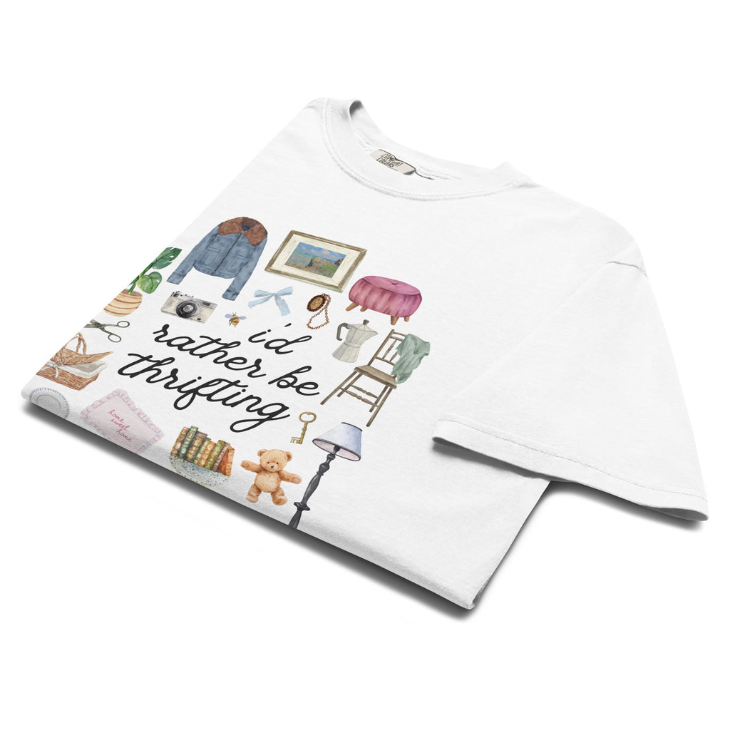 White t-shirt with illustrations and text 'I'd rather be thrifting' on a white background