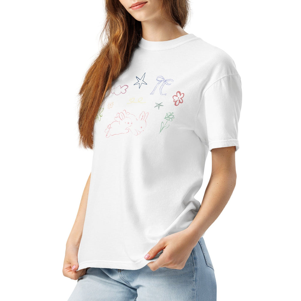 Woman wearing a white t-shirt with spring inspired doodles on a white background