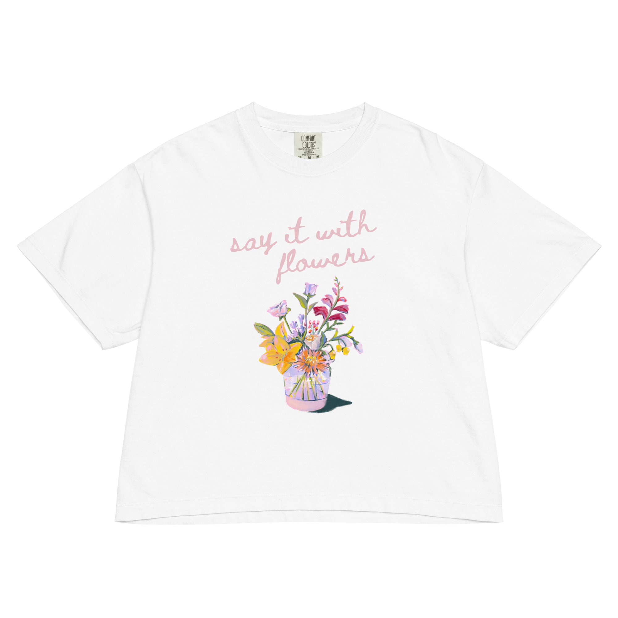 White t-shirt with vase of flowers and text 'say it with flowers' on a white background