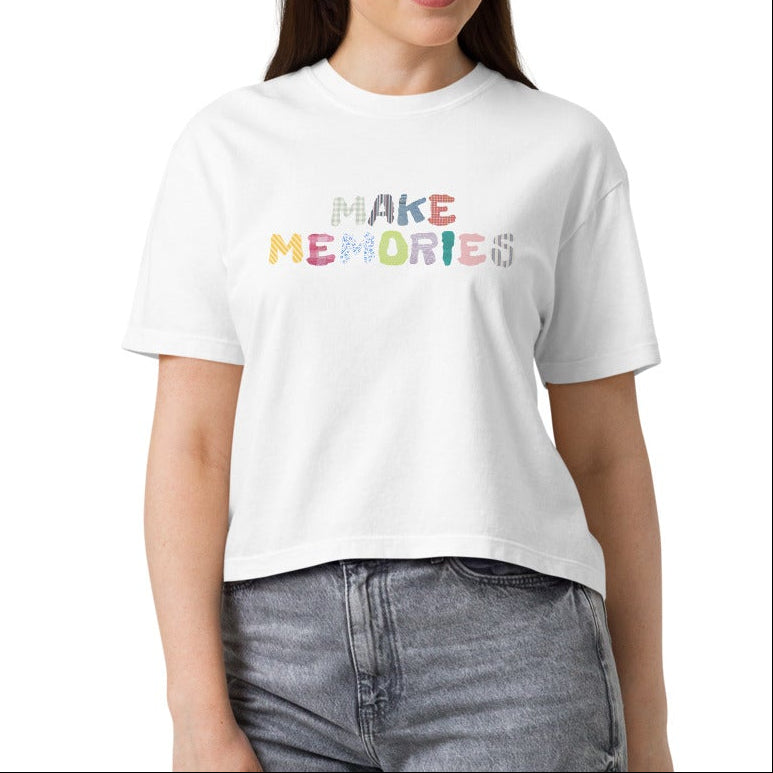 Woman wearing a white t-shirt with "MAKE MEMORIES" in miscellaneous patterns